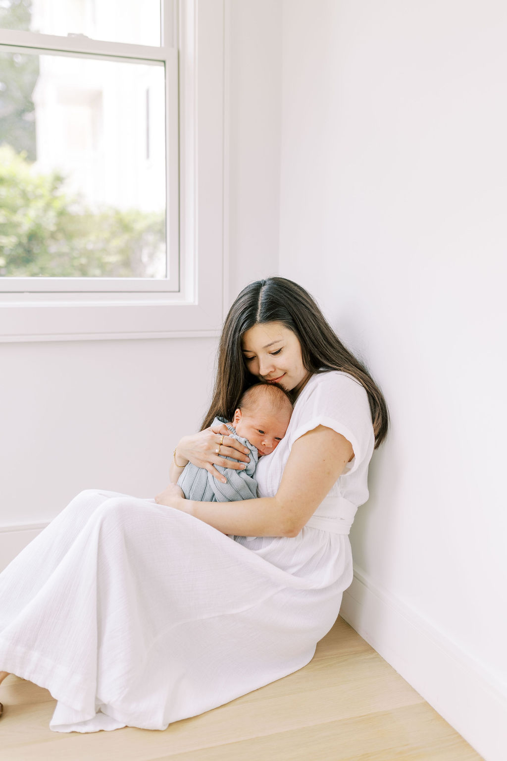 Mom holding baby image taken by Boston Newborn Photographer, Nicole Flores
